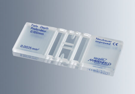 A Counting Chamber with V-slash, Neubauer-Improved, 0.1mm depth, and dark line for cell counting rests on a reflective surface.