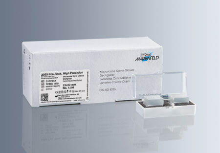 A box labeled "microscope cover glass no. 1.5h, high precision (0.170 ± 0.005mm)" is shown with two stacks of coverslips in a plastic holder in front of it.