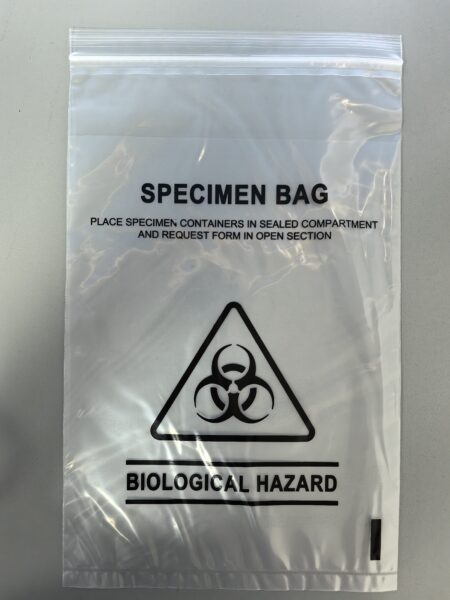 The 3-layered Biohazard Specimen Bag (160mm x 255mm, 100% LDPE clear film, 45µm) features a bold biohazard symbol and designated sections for specimen containers and forms. Pouch size: 160x215mmx32µm. Packed 2000/carton.