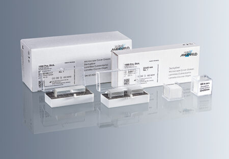 Superior microscope cover glass no.1 thickness (0.13 - 0.16mm) shown in clear packaging, next to branded white Marienfeld boxes.