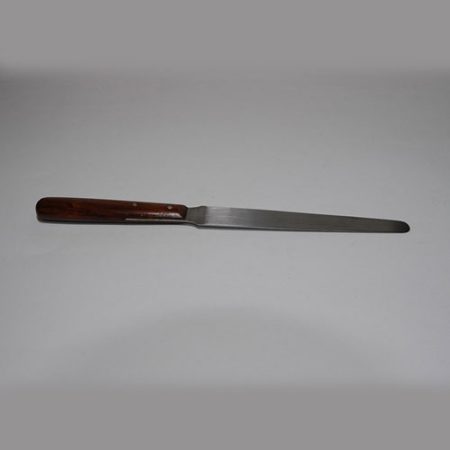 A flexible tapered blade knife with a wooden handle placed on a white surface.