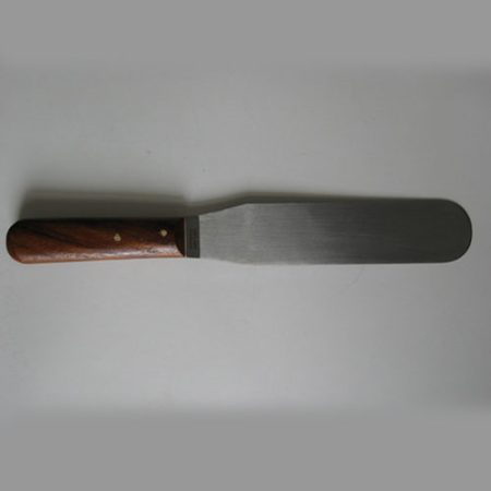 A wide-blade spatula with a wooden handle, measuring 32mm and 200mm in size, used in pharmacology, photographed on a white surface.