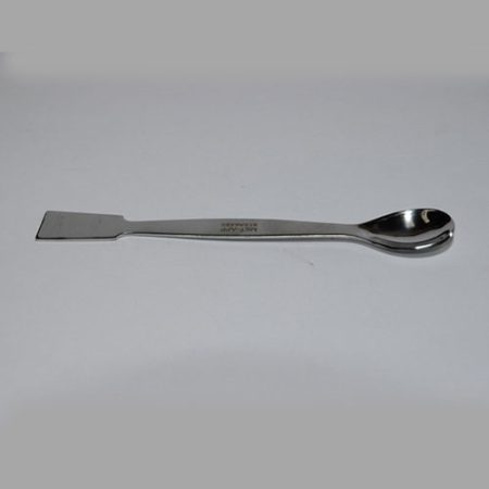 A stainless steel spoon with a handle on a white surface.