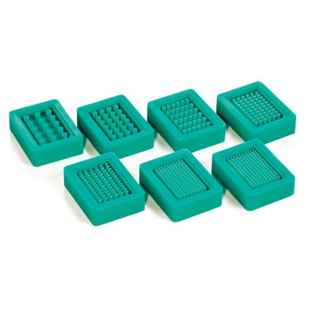 A set of green plastic molds with different shapes.