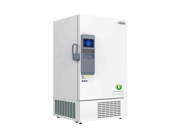 A white Freezer Ultra Low Dual Core System, Upright 780lt, -86°C with a touch-screen control panel and a solid door, featuring a vent at the bottom and standing on small wheels. Equipped with a dual core system, it can maintain temperatures as low as -86°C.