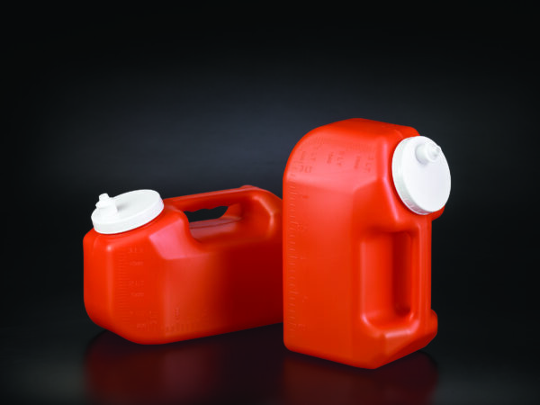 Two red plastic containers from the "24hr urine collection bottles" product line with white caps are placed on a black background. One container is standing upright while the other is lying on its side, resembling their careful arrangement in promotional or instructional materials.