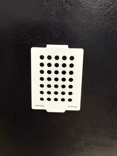 Plastic Covers White for Standard Cassettes: white rectangular plastic covers with multiple round holes in rows, designed to fit standard cassettes. Packed 3000 per carton.