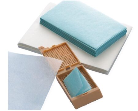 Stacks of blue Biopsy Wrap paper for Tissue Biopsies, 51mm x 76mm (2" x 3"), 500 per pack, with several sheets in a small brown plastic case, displayed against a plain background.