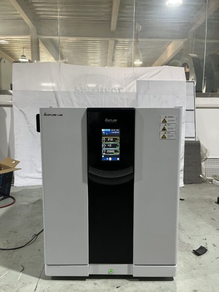 A co2 incubators, air jacket model with a digital display panel is placed on a concrete floor in an industrial environment.