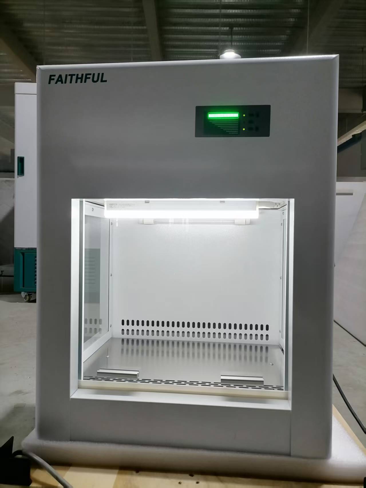 A Laminar Flow Cabinet, Vertical Class 100, featuring a colour screen LCD controller for operator and environment protection, with an illuminated interior.