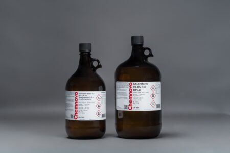 Two brown glass bottles labeled "Chloroform 99.8% for HPLC" with hazard symbols, placed side by side on a neutral gray background.