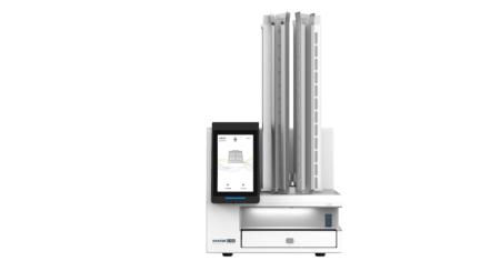 The SurePrint C100 Laser Cassette Printer with Carousel for 6 Colours^ has a touchscreen display, vertical storage columns, and a 6-colour carousel, all displayed on a plain white background.