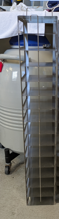 The Cryogenic Rack for Biobank Series features 16 layers for 9x9 cryoboxes, standing upright on a concrete floor near lab equipment—ideal for efficient biobank storage.