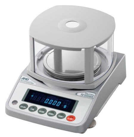 A digital analytical balance with a round weighing pan, transparent draft shield, and digital display showing a zero reading.