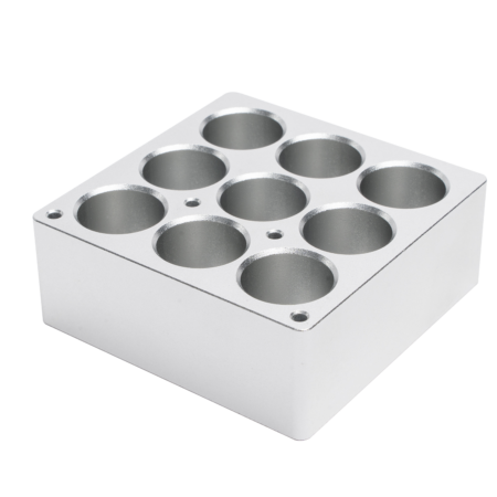 A silver metal block with eight cylindrical holes arranged in two rows of four, viewed at an angle on a white background.