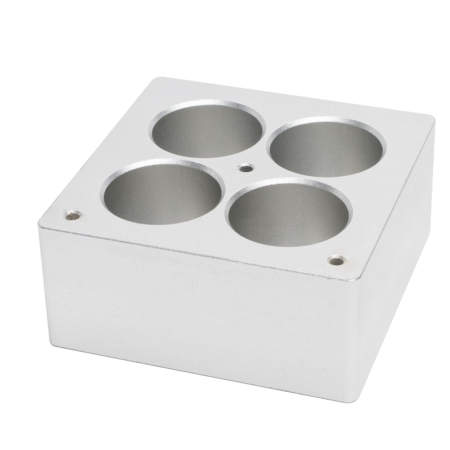 A rectangular silver metal block with four evenly spaced circular holes on its top surface and two small screw holes at opposite corners.