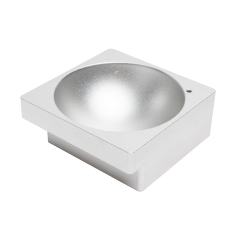 A metallic, square-shaped object with a hemispherical indentation in the center, resembling an industrial or laboratory component, set against a plain white background.