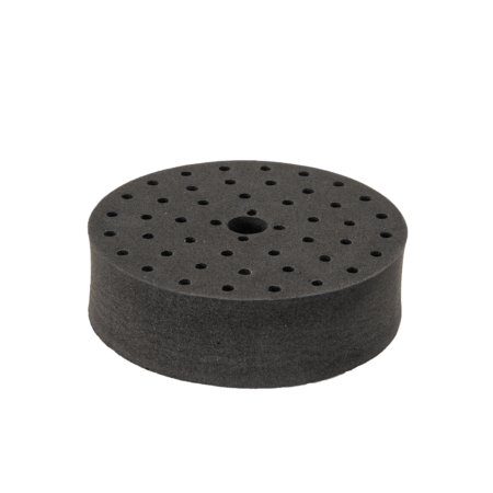 Round black foam sanding pad with multiple small holes and a single larger center hole, displayed on a white background.