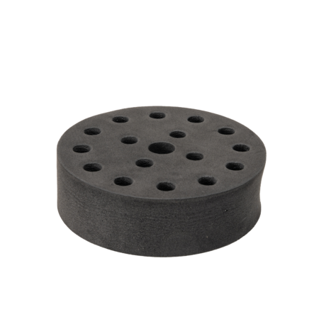 Round black foam disc with multiple holes of varying sizes evenly spaced across its surface, shown on a plain white background.