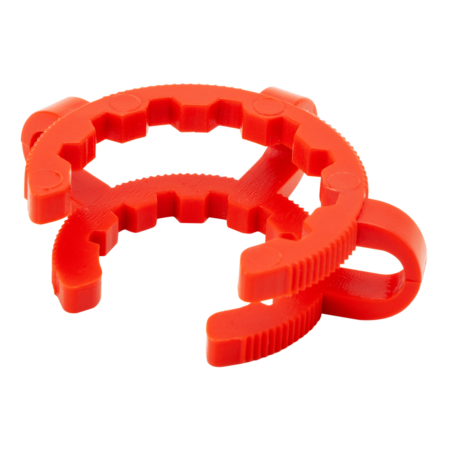 A red plastic tool with a circular, toothed design and a side clip, likely used for gripping or adjusting round objects such as pipes or bottle caps.