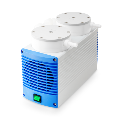 A white and blue laboratory vacuum pump with two circular ports on top and a green power switch on the front.