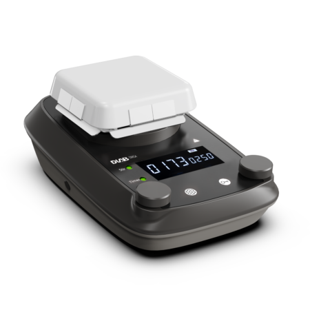 A digital laboratory hotplate stirrer with a white square platform, two control knobs, and an LED display showing temperature and time on a black base.