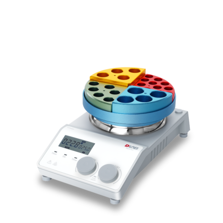 A digital laboratory hot plate with a circular, multicolored tube rack holding different colored tube holders on top.
