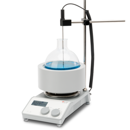 A laboratory hot plate setup with a round-bottom flask containing blue liquid, a heating mantle, a digital display, and a temperature probe stand.
