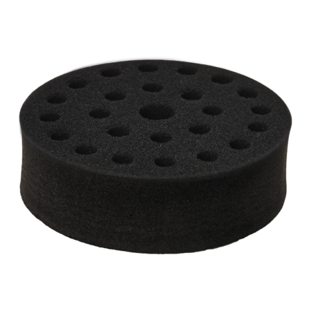 A round black foam disc with multiple holes of various sizes on its surface, set against a plain white background.
