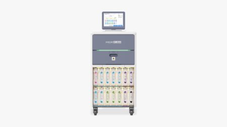 A medical dispensing cart with a touchscreen interface on top and multiple labeled medication drawers below, set against a plain white background, echoing the streamlined efficiency of the HP Hugo Automatic Tissue Processor, which accommodates up to 200 cassettes with 100 cassettes per basket.